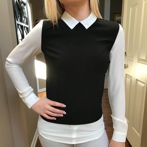 Dressy white collared long sleeved black top.